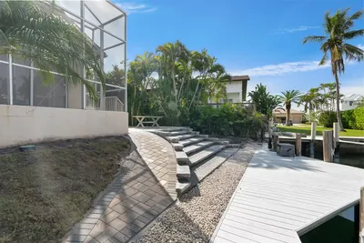 Steps and paver walkway next to a pier